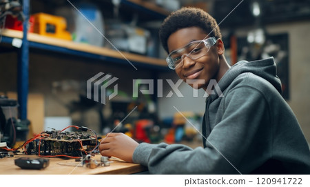 Teenage innovator in electronics workshop, exploring stem concepts for educational growth and future careers 120941722