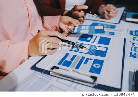 Young Asian business creative team work together, mobile application software design project. Brainstorm meeting, internet technology, smartphone web app designer, office coworker teamwork concept Young Asian business creative team work together, mobile application software design project. Brainstorm meeting, internet technology, smartphone web app designer, office coworker teamwork concept 120942474