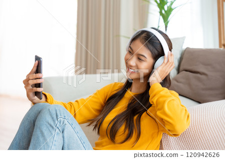 Happy young asian woman relaxing at home 120942626