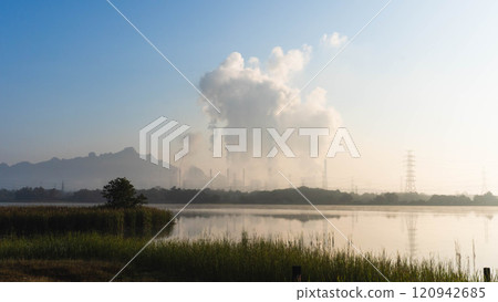 Aerial view of a coal-fired power plant with steam flowing out of the stack in the morning. Mae Moh Power Plant, Lampang, Thailand. Aerial view of a coal-fired power plant with steam flowing out of the stack in the morning. Mae Moh Power Plant, Lampang, Thailand. 120942685