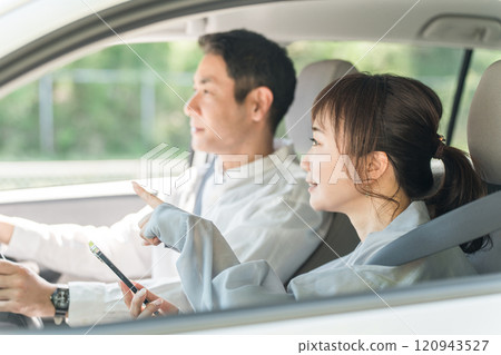 A middle-aged couple having a pleasant conversation while driving 120943527