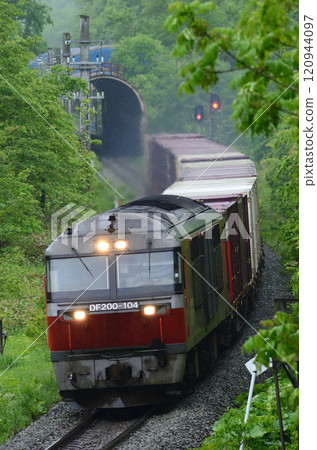 A freight train on the Sekisho Line rushing through Osawa Signal Station in the rain A freight train on the Sekisho Line rushing through Osawa Signal Station in the rain 120944097