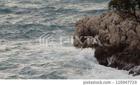 sea waves crushing over rocks with soft light 120947729