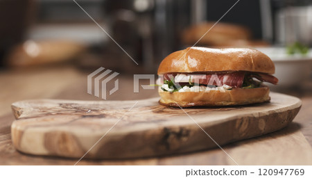 bagel sandwich with prosciutto and cream cheese on wood board bagel sandwich with prosciutto and cream cheese on wood board 120947769