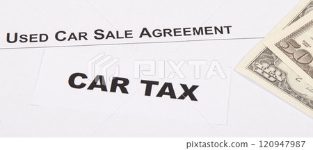 Inscription car tax, dollar banknotes and vehicle sales agreement 120947987