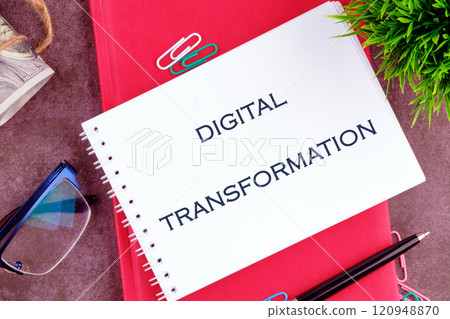 Big data and networking concept. DIGITAL TRANSFORMATION in a mini notebook on a business book, close-up. Copy space Big data and networking concept. DIGITAL TRANSFORMATION in a mini notebook on a business book, close-up. Copy space 120948870