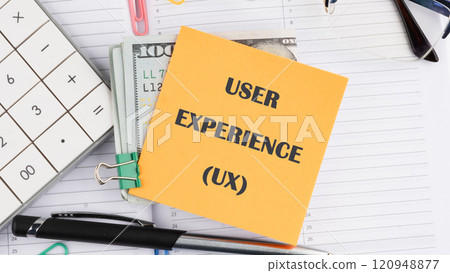Business concept. Copy space. USER EXPERIENCE it is written on a sticker on the background of an open notebook Business concept. Copy space. USER EXPERIENCE it is written on a sticker on the background of an open notebook 120948877
