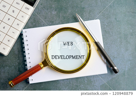Technology concept. Words WEB DEVELOPMENT in a clean notebook on a gray background, top view Technology concept. Words WEB DEVELOPMENT in a clean notebook on a gray background, top view 120948879