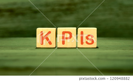 Business strategists. Copy space. The abbreviation KPIs It is written on wooden cubes on a green background Business strategists. Copy space. The abbreviation KPIs It is written on wooden cubes on a green background 120948882