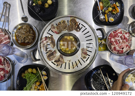 Korean barbecue feast with grilled meat and sides Korean barbecue feast with grilled meat and sides 120949172