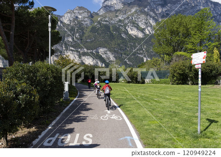 Cyclists on a trail in the Dolomites Cyclists on a trail in the Dolomites 120949224