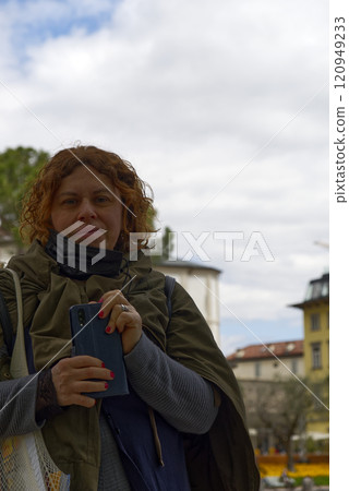 Portrait of woman in profile resting on the nature near the river. Sunny simmer day 120949233