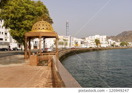 Golden ornated dome gazebo in traditional Omani style with port and cruise ships in the background, Golden ornated dome gazebo in traditional Omani style with port and cruise ships in the background, 120949247