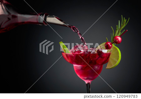 Cranberry cocktail garnished with berries, lime, and rosemary. Cranberry cocktail garnished with berries, lime, and rosemary. 120949783