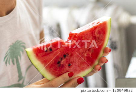 Shot of the woman eating watermelon 120949982
