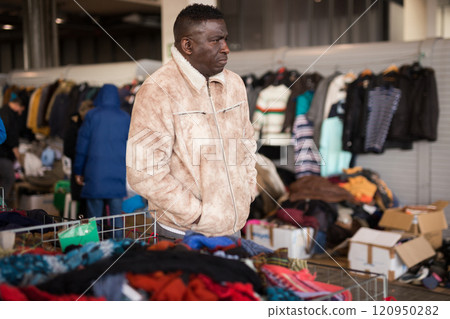 Male vendor at a flea market waits for customers 120950282