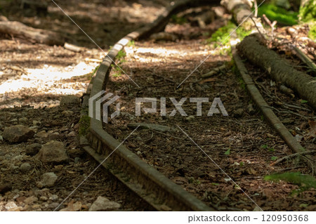 Rusty trolley tracks remaining beside a hiking trail in the northern Yatsugatake mountains 120950368