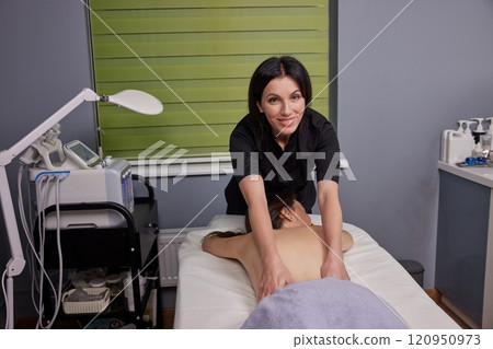 Natural Aromas, Essential Relaxation, Fragrant Oils. Beauty spa is pampering woman with exquisite massage that utilizes benefits essential oils. Natural Aromas, Essential Relaxation, Fragrant Oils. Beauty spa is pampering woman with exquisite massage that utilizes benefits essential oils. 120950973