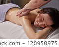 Luxurious Treatment, Spa Ambiance, Luxurious Aromatherapy. Woman is being treated to therapeutic massage session that utilizes power essential oils at spa. 120950975
