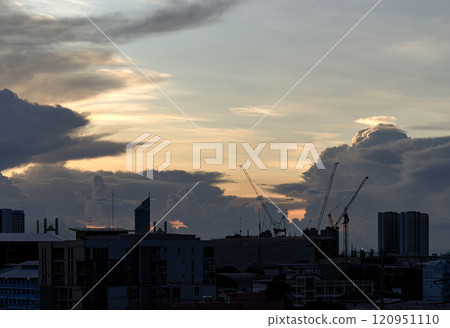 Silhouette view of Construction of tall buildings with a crane and background of Dramatic sky in the city of Bangkok. Silhouette view of Construction of tall buildings with a crane and background of Dramatic sky in the city of Bangkok. 120951110