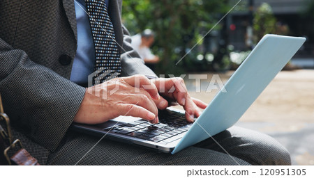 City, hands and laptop with business person outdoor for commute, remote work or travel closeup. Computer, email and typing with corporate employee in Japan for information, reading or research City, hands and laptop with business person outdoor for commute, remote work or travel closeup. Computer, email and typing with corporate employee in Japan for information, reading or research 120951305