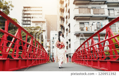 Back, bridge and kimono with woman in city of Tokyo, Japan for culture, sightseeing or travel. Adventure, explore and walking with person outdoor in urban town at location for history or tradition 120951392