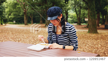 Park, woman and eating with takeaway of food as lunch on break, relax and enjoy in Japan. Outdoor, female person and chopstick with noodles as meal, snack and cuisine at forest with memories and rest 120951467