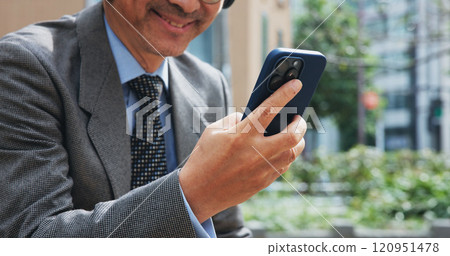 Phone, hands and businessman in city for email, communication or networking with online investor. Technology, contact and finance executive on cellphone for company revenue report in town in Japan. Phone, hands and businessman in city for email, communication or networking with online investor. Technology, contact and finance executive on cellphone for company revenue report in town in Japan. 120951478