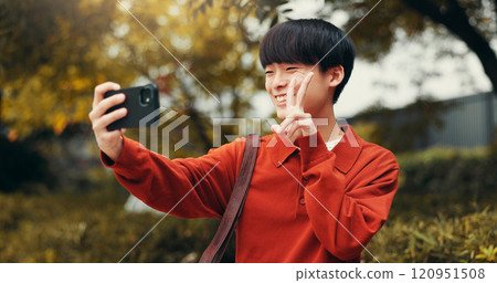 Selfie, peace sign and man in park with social media, outdoor live streaming or online communication. Nature, photography and Japanese streamer with content creation, networking or web connectivity 120951508