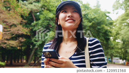 App, phone and thinking with woman in park for adventure, sightseeing or travel to explore Japan. Directions, idea and social media with smile of happy tourist person in nature to search internet map 120951568