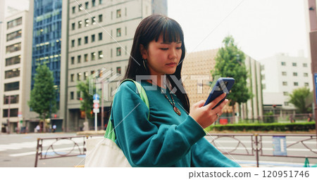Japanese, woman and travel with phone in city for communication, social media and chat notification. Girl, commute and mobile for navigation app of location, reading blog and website texting in Japan 120951746