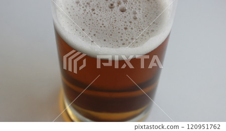 Rich color of semi-dark draught beer in a mug on white background top view 120951762