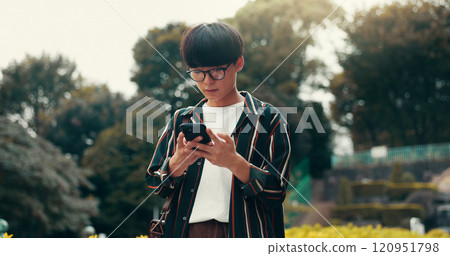 Phone, search and online with Japanese man at college for student portal, education and University website. Social media, networking and reading with person and outdoor for streaming and chat 120951798