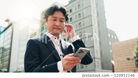 Earphones, travel and businessman with smartphone, city and listening to app, commuting and morning. Outdoor, audio and watching news with mobile, real estate agent and Japanese person in Japan 120952146
