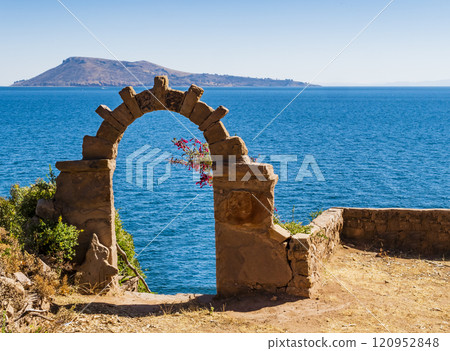 Landscape on island Taquile with stone arch, Puno region, Peru 120952848