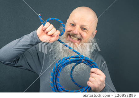 Portrait of a Bald, Bearded Man With a Blue Mountaineering Rope 120952899