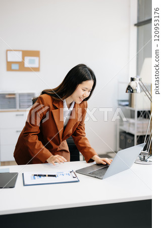 Business woman using tablet and laptop for doing math finance on an office desk, tax, report, accounting, statistics, 120953176