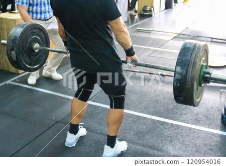 Weightlifter Prepares for Deadlift in a Gym During Training Session 120954016
