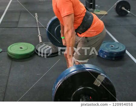 Weightlifting Session in a Gym Focusing on Deadlift Technique and Strength Training 120954058