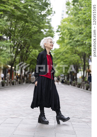 A senior woman with gray hair walking down the street A senior woman with gray hair walking down the street 120955595