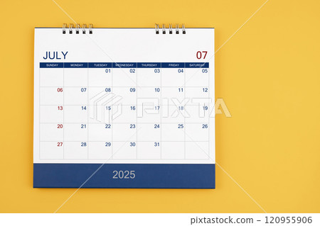 July 2025 desk calendar on the yellow table, planning for business meeting concept. 120955906