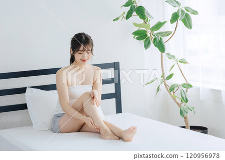 做腿的婦女護膚在床上 120956978