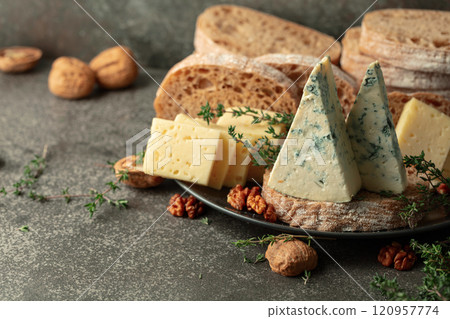 Cheese, bread, walnuts, and thyme on a stone kitchen table. Cheese, bread, walnuts, and thyme on a stone kitchen table. 120957774