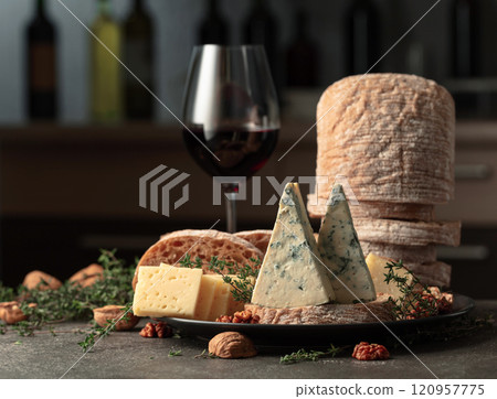 Cheese, bread, walnuts, and thyme on a kitchen table. Cheese, bread, walnuts, and thyme on a kitchen table. 120957775