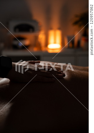 Woman masseuse doing professional back massage to man in spa salon. Woman masseuse doing professional back massage to man in spa salon. 120957862