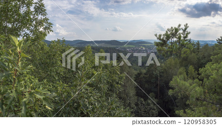 Panoramic view from viewpoint Stredni vrch near Dolni Prysk, Ceska Kamenice. Autumn landscape with colorful forest, hills and blue cloudy sky in Luzicke hory Lusatian Mountains, Czech Republic. 120958305