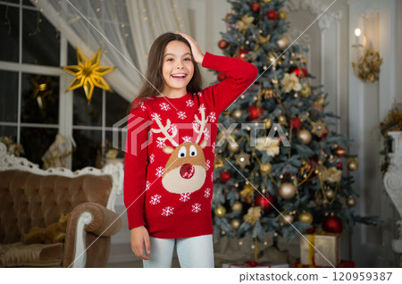 small happy girl at christmas. Christmas. Kid enjoy the holiday. Happy new year. morning before Xmas. New year holiday. little child girl likes xmas present. Christmas party time. favorite sweater small happy girl at christmas. Christmas. Kid enjoy the holiday. Happy new year. morning before Xmas. New year holiday. little child girl likes xmas present. Christmas party time. favorite sweater 120959387
