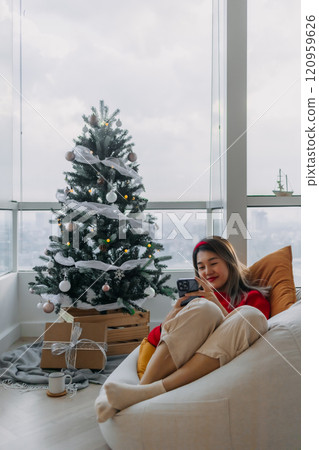 Happy woman in red sweater call and chat on the phone to merry her friends and family in Christmas holiday. 120959626