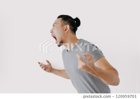 Angry and furious shouting face of man in grey t-shirt isolate on white. Angry and furious shouting face of man in grey t-shirt isolate on white. 120959701