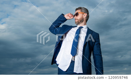 carefree business man in suit on sky background, banner. carefree business man in suit outdoor. carefree business man in suit on sky background, banner. carefree business man in suit outdoor. 120959746